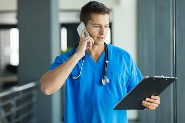 doctor talking on phone looking at notepad